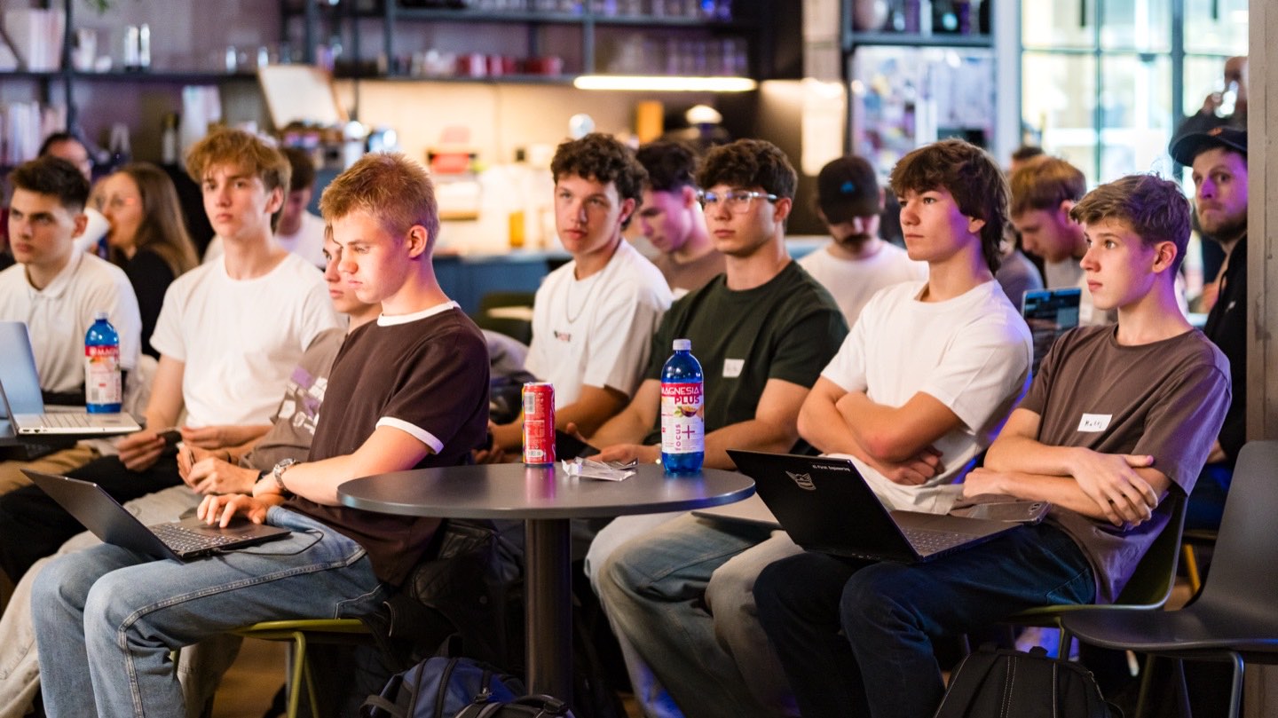 Participants seated with laptops listening to the opening talks at Productboard